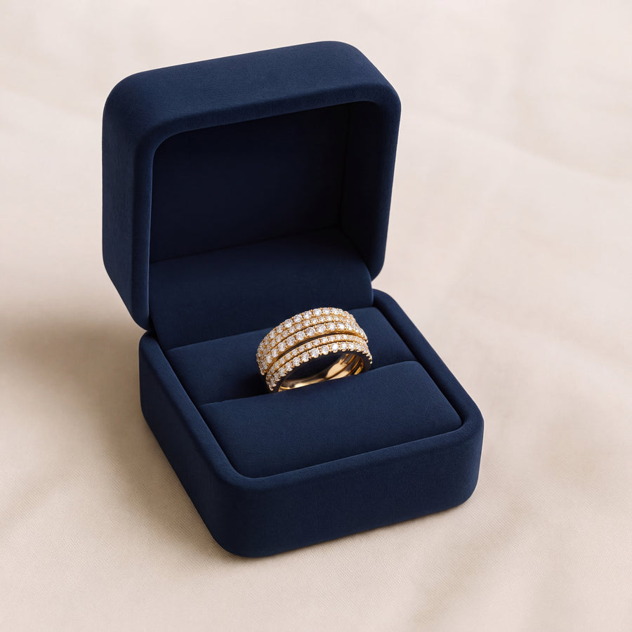 Wide yellow gold ring with five rows of round diamonds, made to look like stacked bands