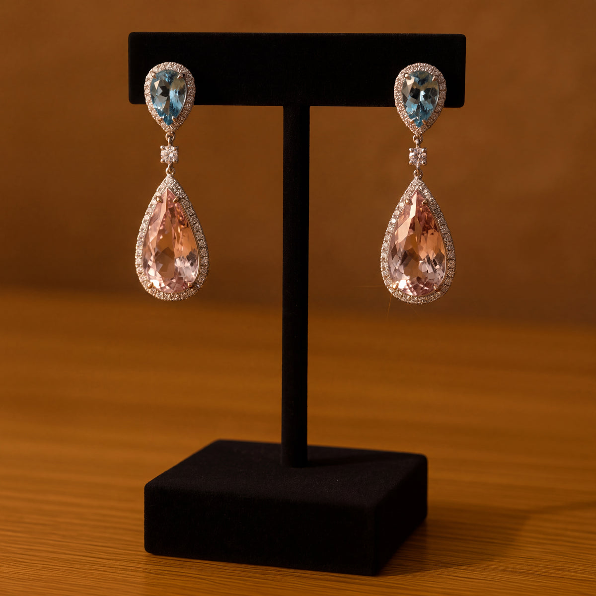 Halo drop earrings with a pear blue gemstone top and a large pear morganite drop