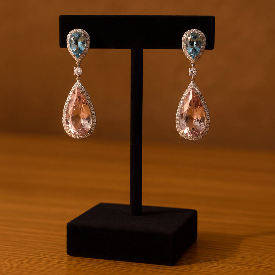 Halo drop earrings with a pear blue gemstone top and a large pear morganite drop