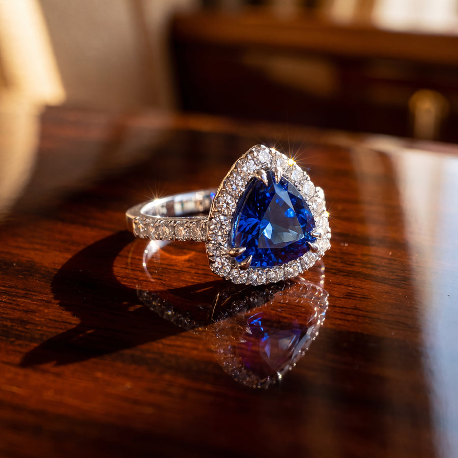 Trillion-cut tanzanite in a halo with diamond-set shoulders