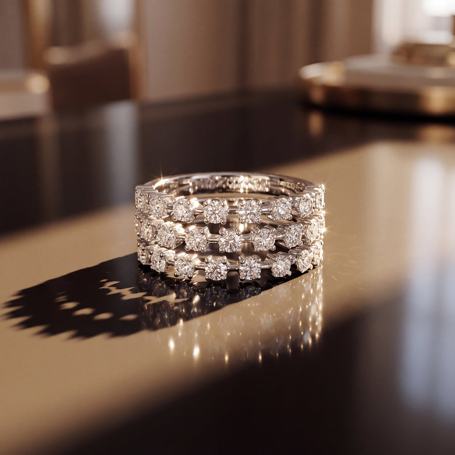 White gold ring with three separate rows of round brilliant diamonds and open gaps between them