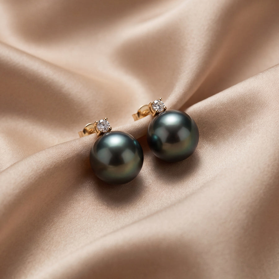 Grey pearl stud earrings each topped with a small diamond