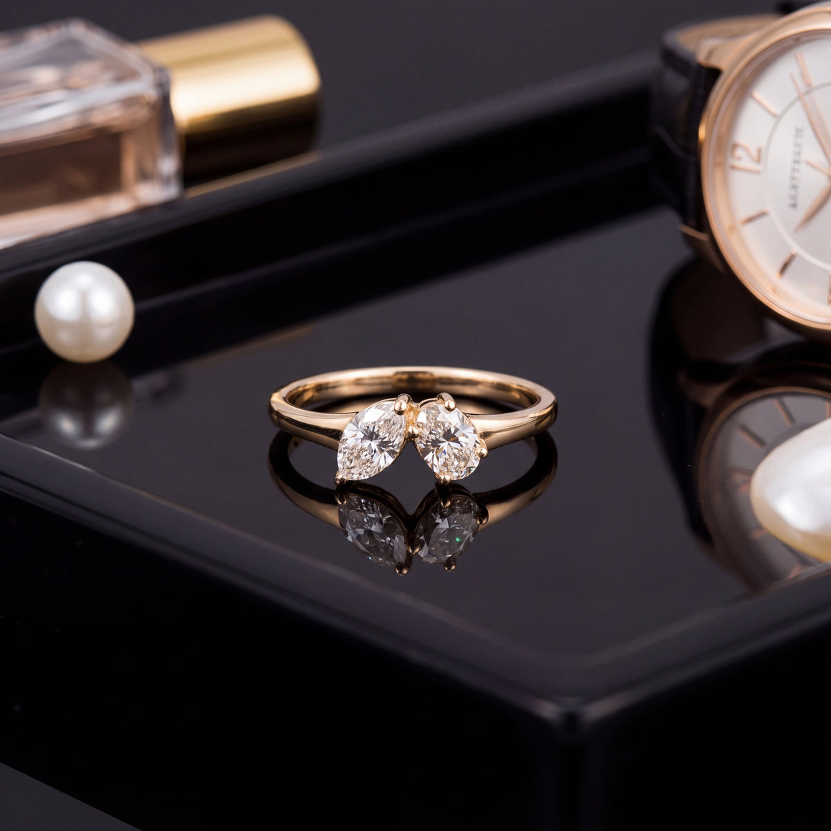 Two diamonds set side by side at an angle on a slender yellow gold band