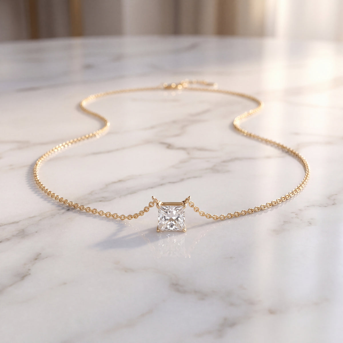 Princess-cut diamond solitaire on a fine yellow gold chain