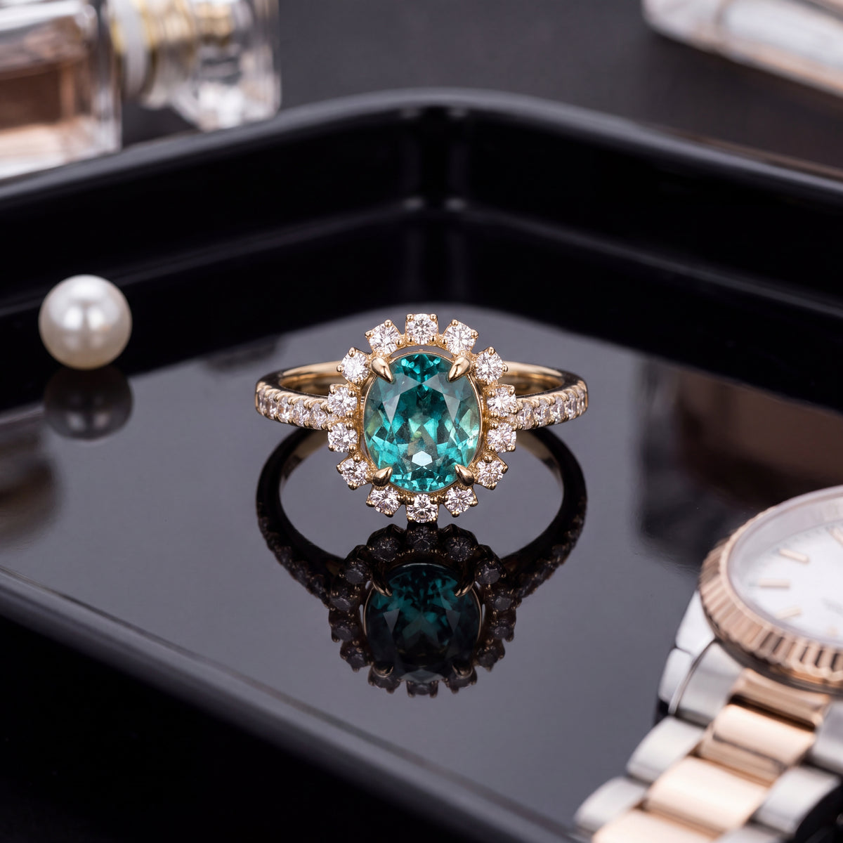 Oval blue-green Paraiba tourmaline in a round diamond halo with diamond-set shoulders on a yellow gold band