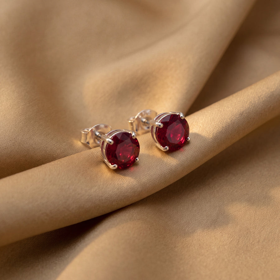 Pair of round-cut solitaire stud earrings in four-prong settings