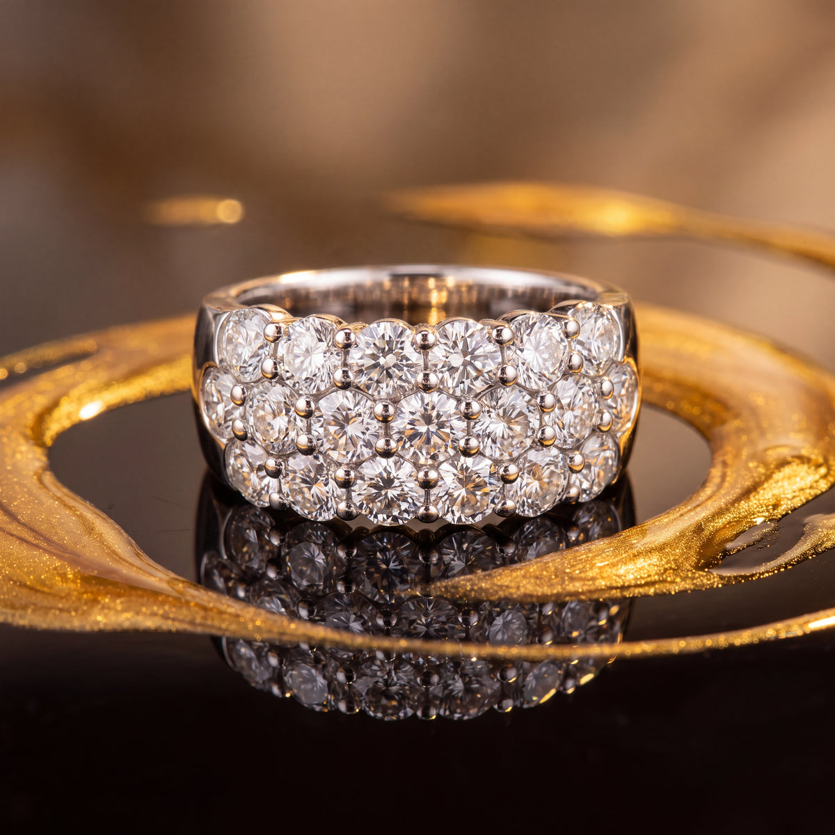 Wide white gold band ring with three close-set rows of round brilliant diamonds across the top