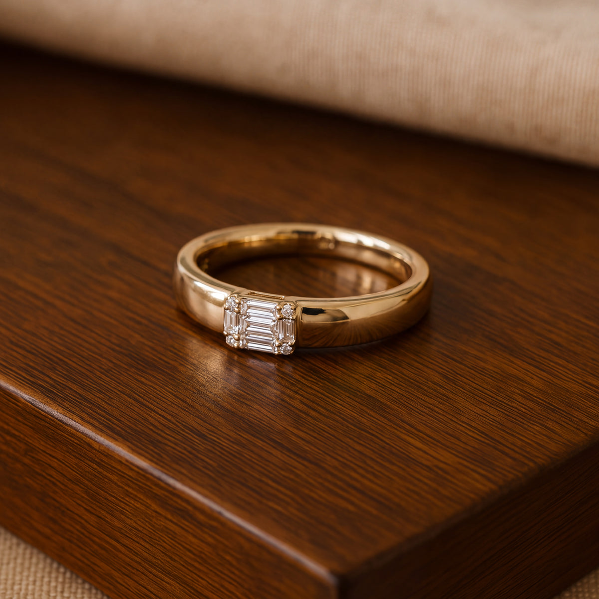 Yellow gold band with a rectangular cluster of baguette and round diamonds