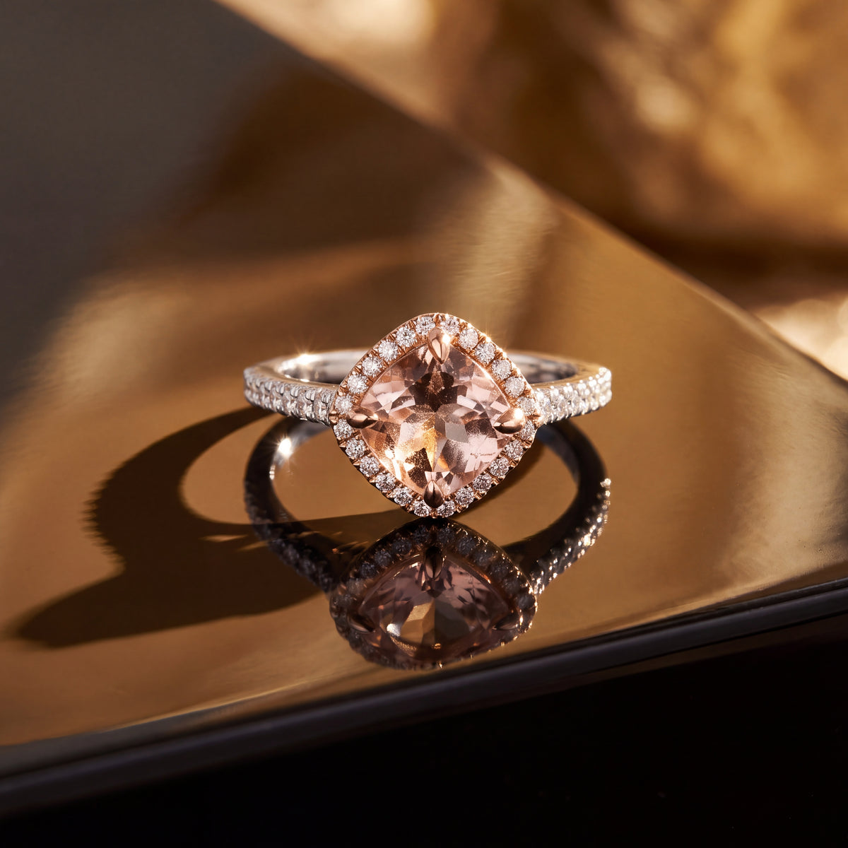 Cushion-cut pink morganite in a rose gold diamond halo on a white gold band lined with diamonds