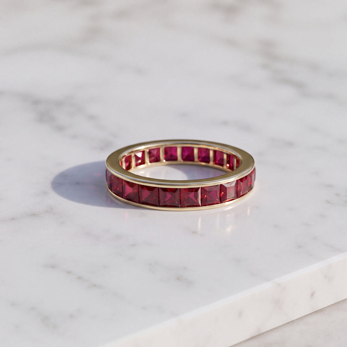 Eternity ring of square-cut rubies channel-set in 14K yellow gold
