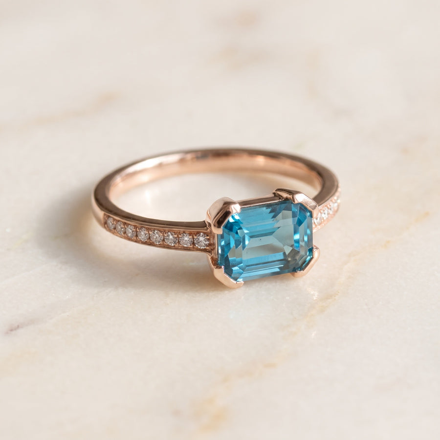 East-West Emerald-Cut Blue Topaz Ring in Rose Gold
