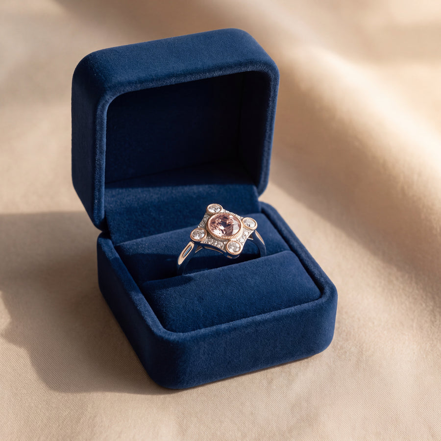 Round morganite cocktail ring with a diamond-shaped halo, milgrain edges and four bezel-set diamonds in rose and white gold