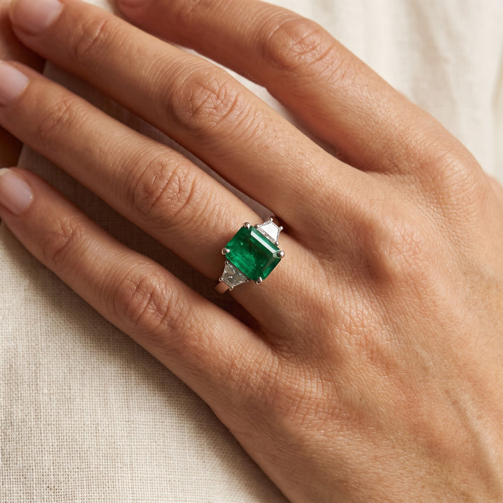 4.15 ct Emerald and Trapezoid Diamond Three-Stone Ring in 14K White Gold, worn