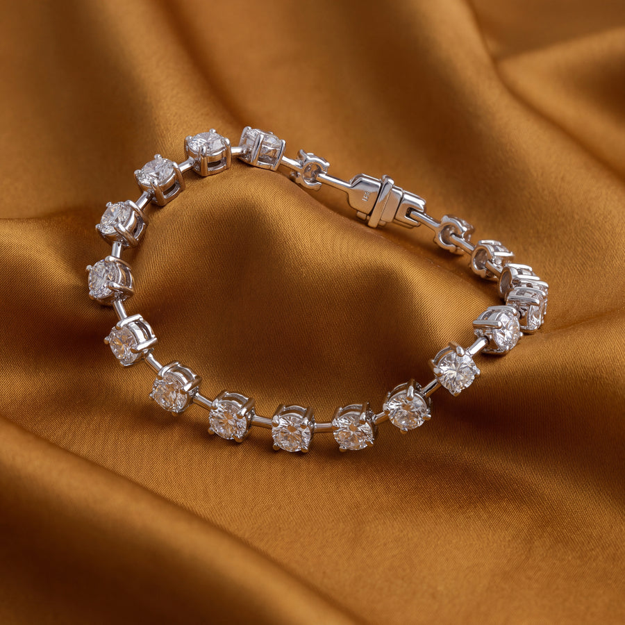White gold bracelet of round diamonds in spaced station links