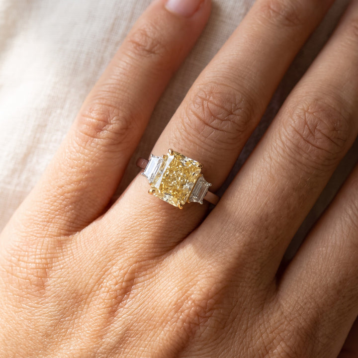 Radiant Cut Fancy Yellow Diamond Three-Stone Ring in White Gold, worn