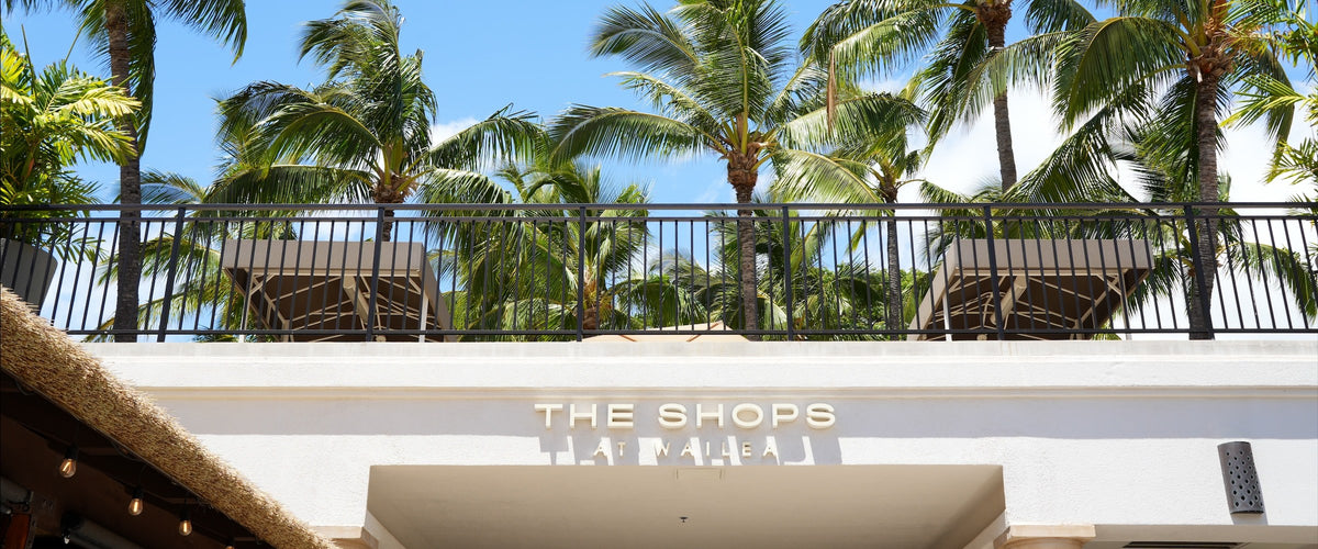 The Shops at Wailea entrance sign under palm trees