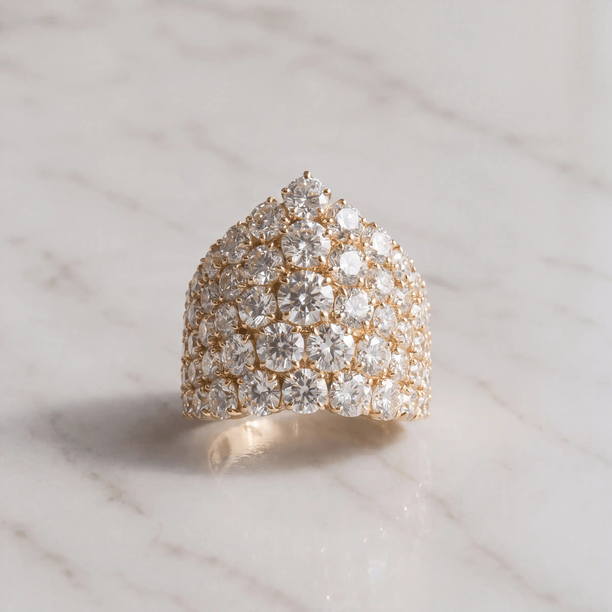A sculptural diamond-covered ring on pale marble