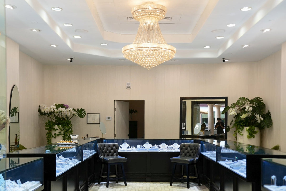 The back counter at Greenleaf Diamonds, two leather stools under the chandelier