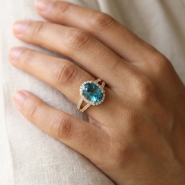 3.54 ct Oval Blue Zircon and Diamond Split Shank Halo Ring in 14K Yellow Gold, worn