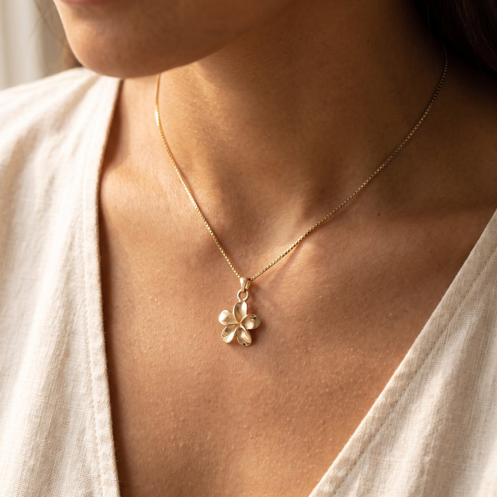 Polished Plumeria Flower Charm Necklace in 14K Yellow Gold, worn
