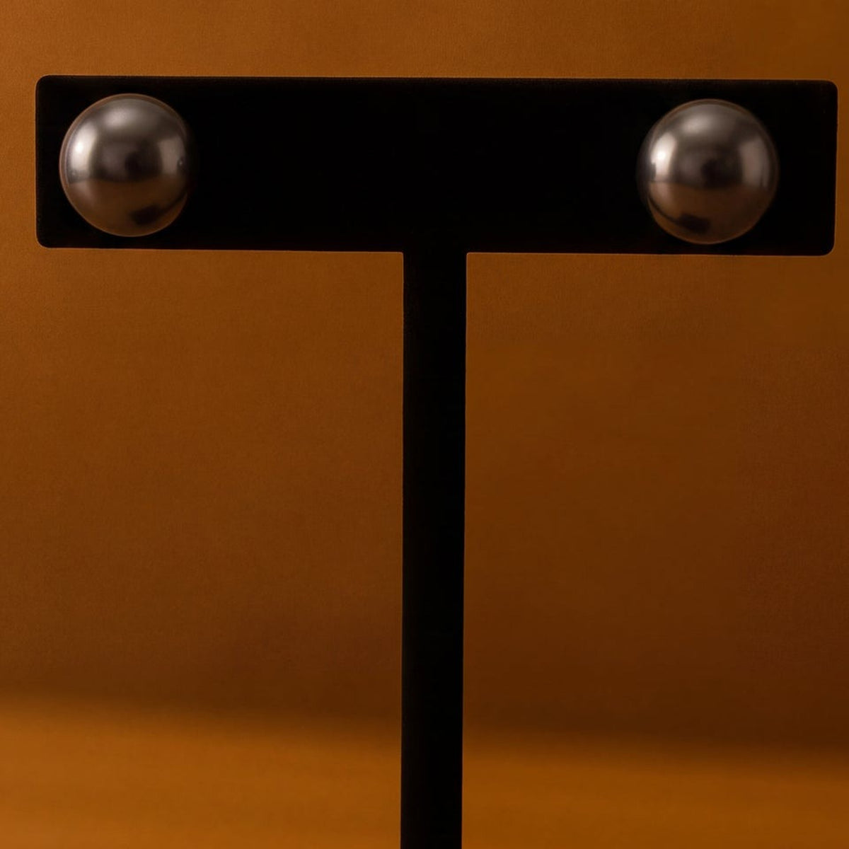 Pair of dark round pearl stud earrings