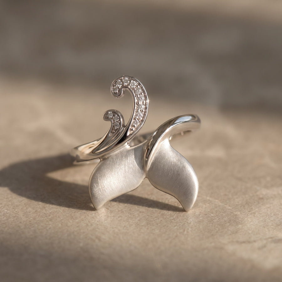 White gold whale tail ring with a diamond wave curl