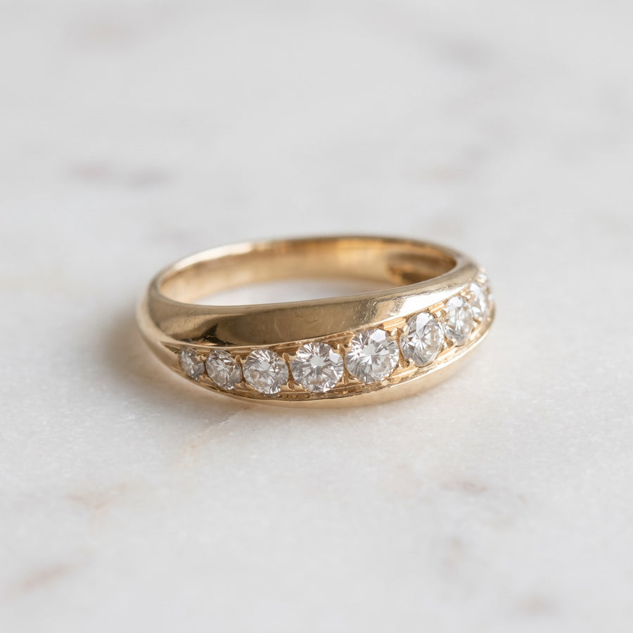 Domed yellow gold band with a graduated row of round diamonds