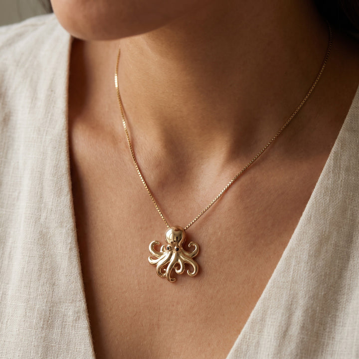 Octopus Charm Necklace with Blue Sapphire Eyes in 14K Yellow Gold, worn