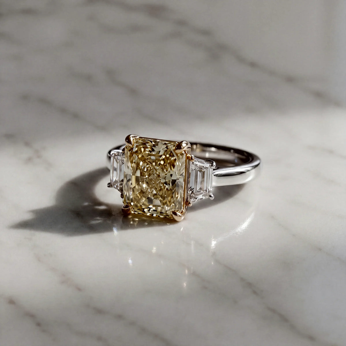 A three-stone ring with a yellow diamond between two white diamonds