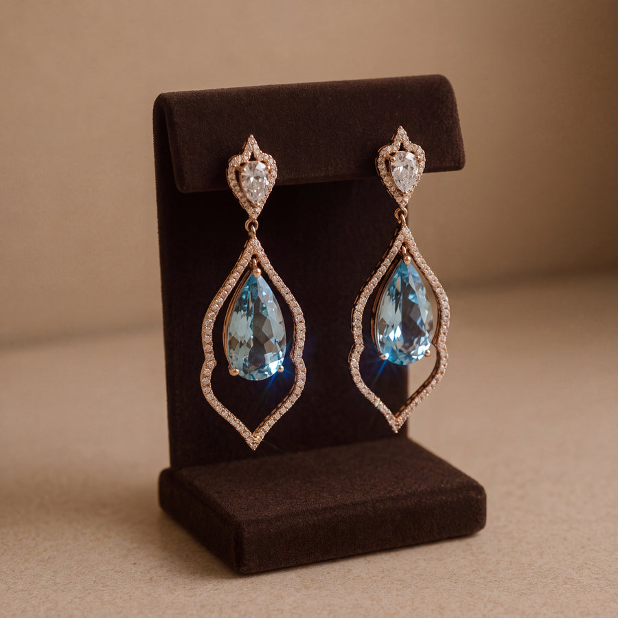 Dangle earrings with pear-cut aquamarines in diamond-set openwork frames below pear-shaped diamond tops, in rose gold