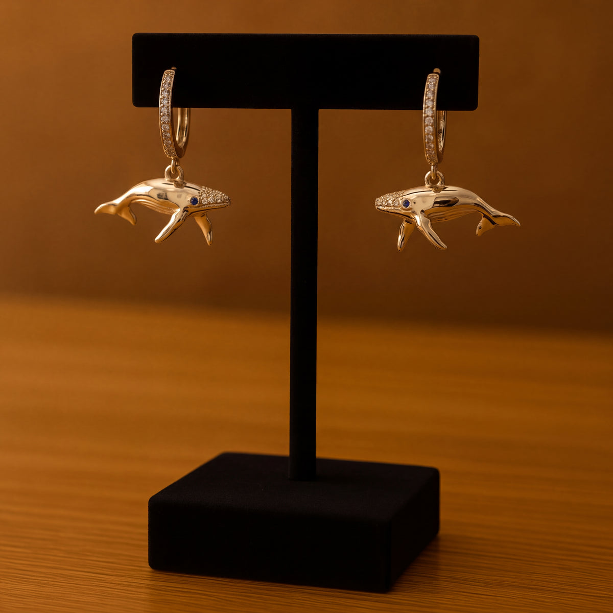 Yellow gold whale drop earrings with blue sapphire eyes on small diamond-set hoops
