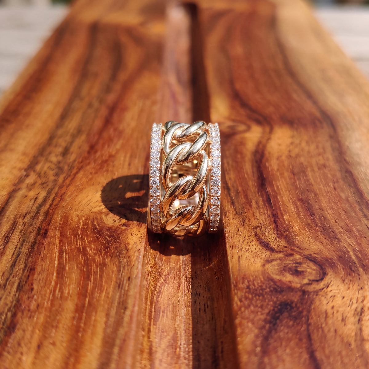 Wide yellow gold band with a chain center and diamond-set edges