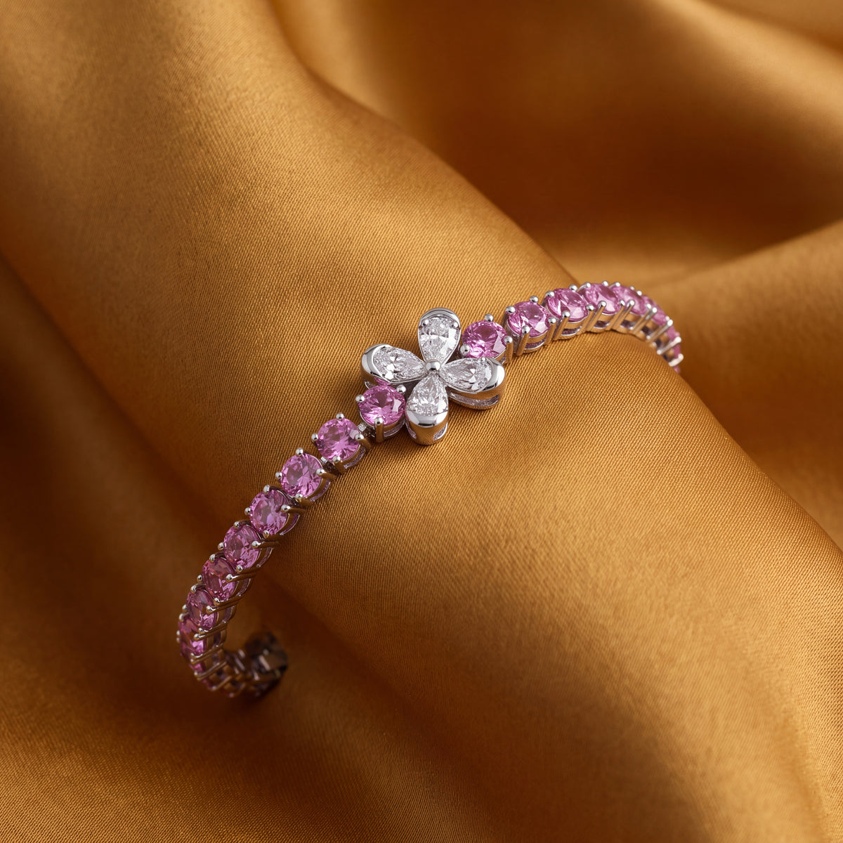 Pink sapphire tennis bracelet in white gold with a flower motif