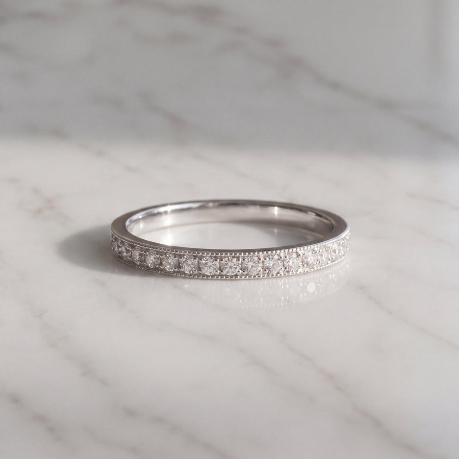A slender white gold pave band edged with fine milgrain beading.