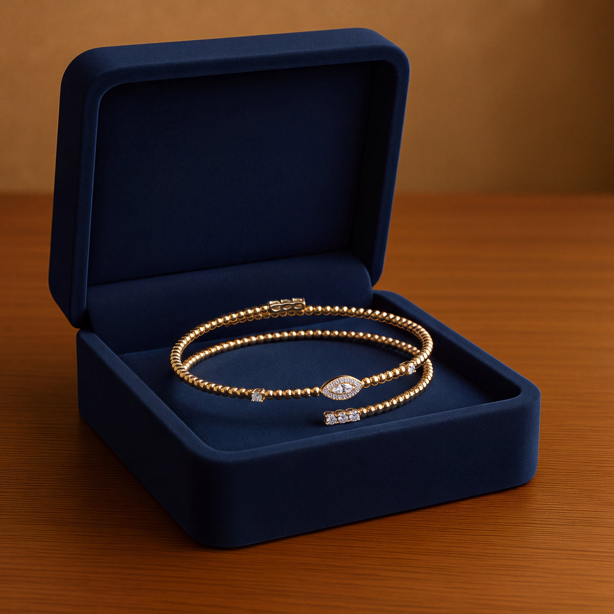 Yellow gold beaded wrap bracelet with a marquise-shaped diamond cluster