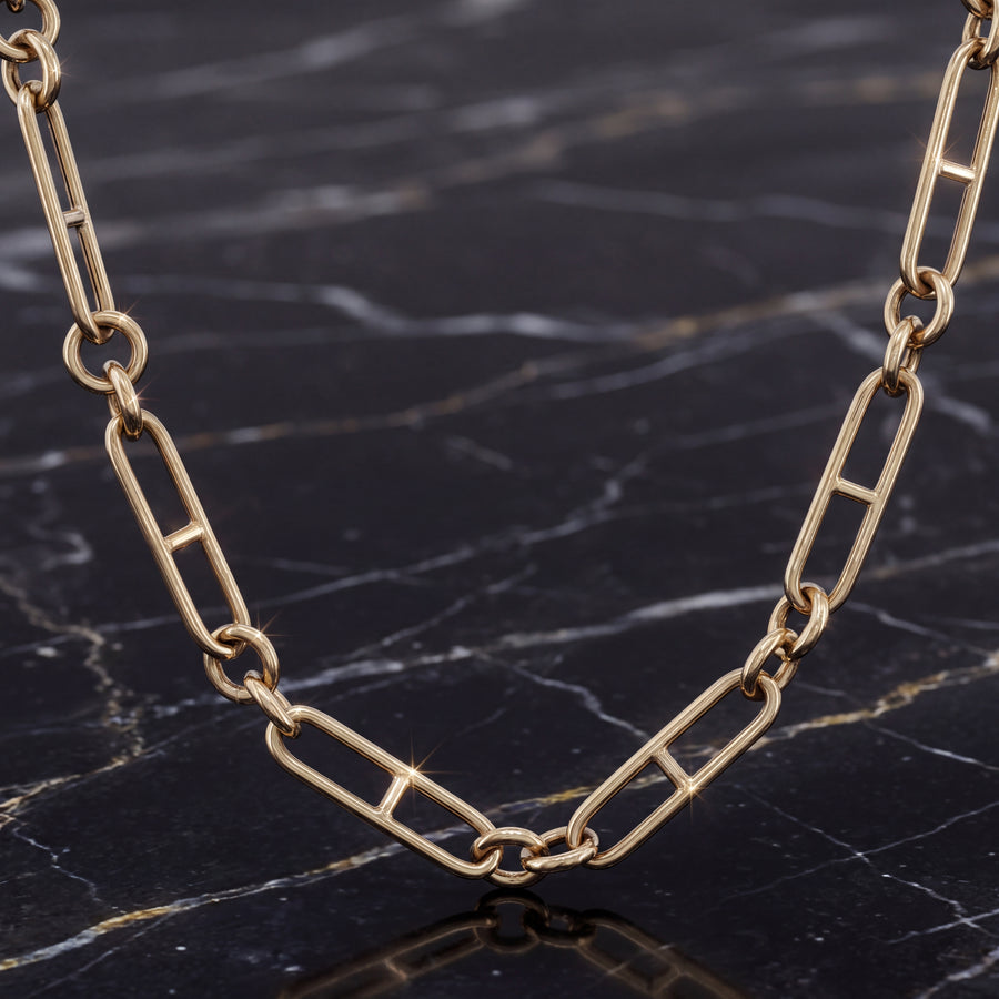 An elongated yellow gold mariner link chain necklace.