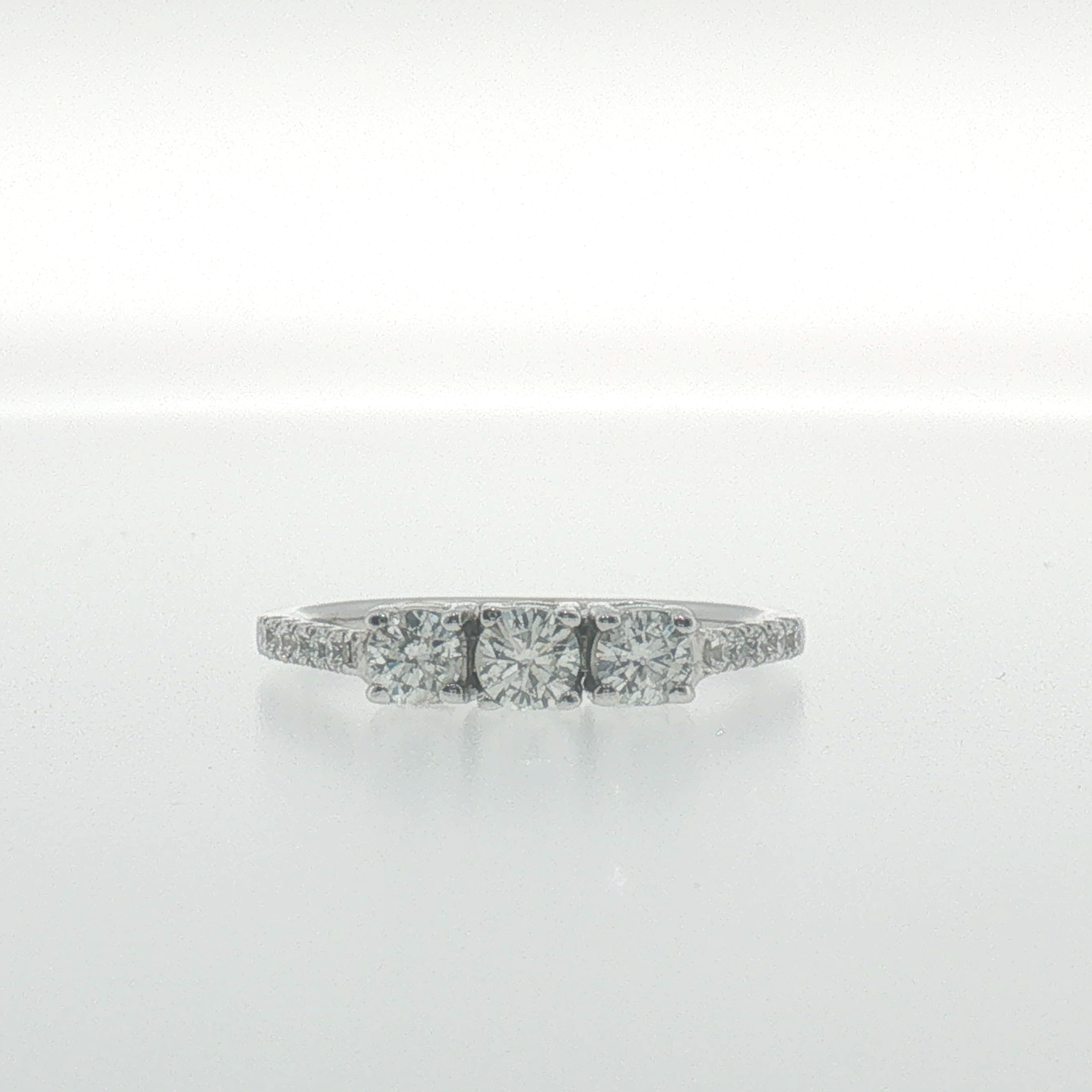 White Gold Three-Stone Diamond Ring with Pavé Band
