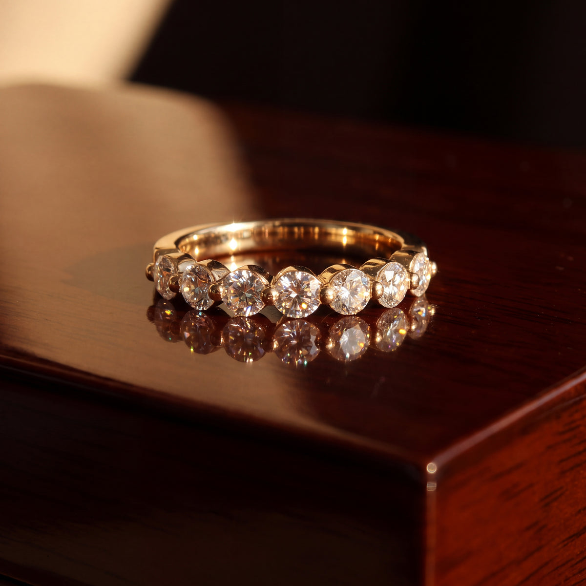 Yellow gold band of round diamonds, each held by a single prong