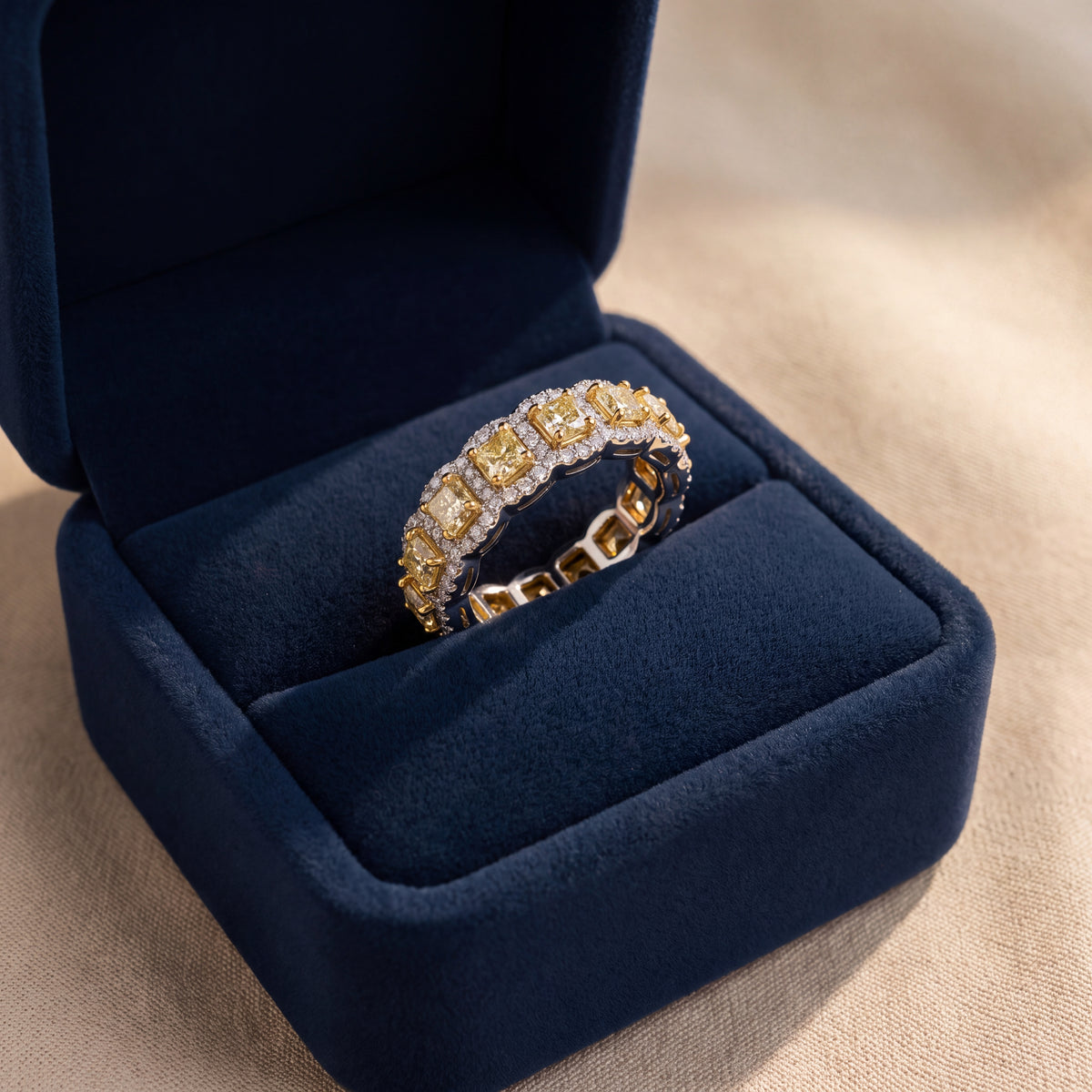 Eternity ring of fancy yellow diamonds in white diamond halos