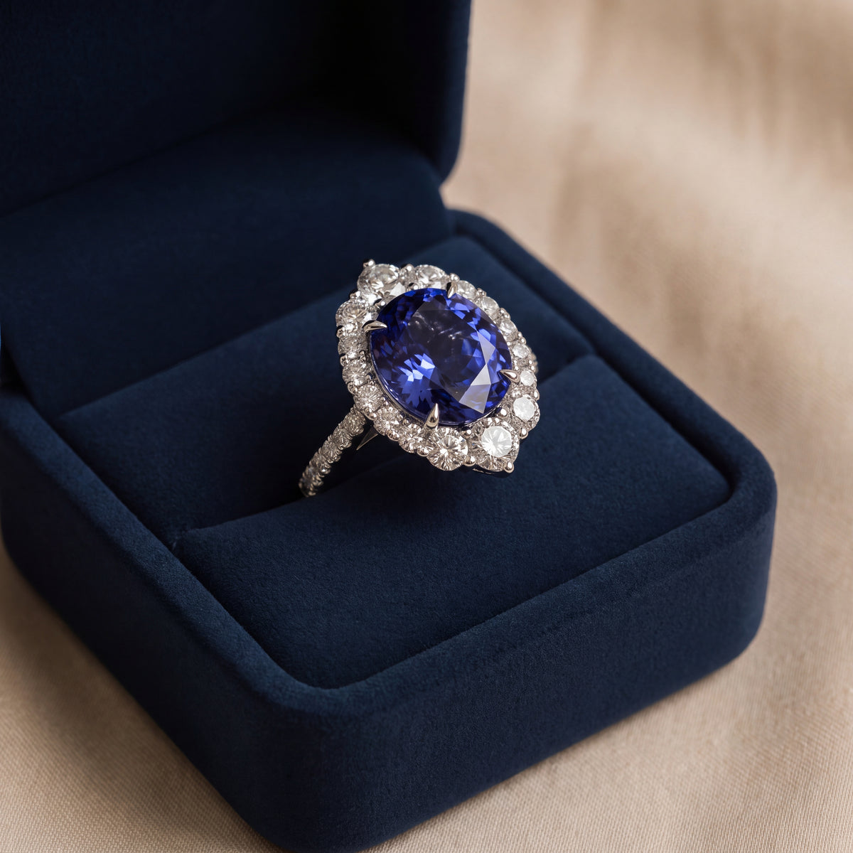 Large tanzanite in a diamond halo on a white gold band