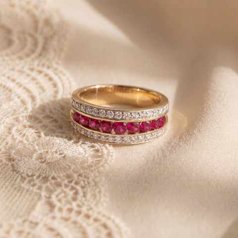 Three-row band ring with round red rubies between two rows of diamonds in yellow gold