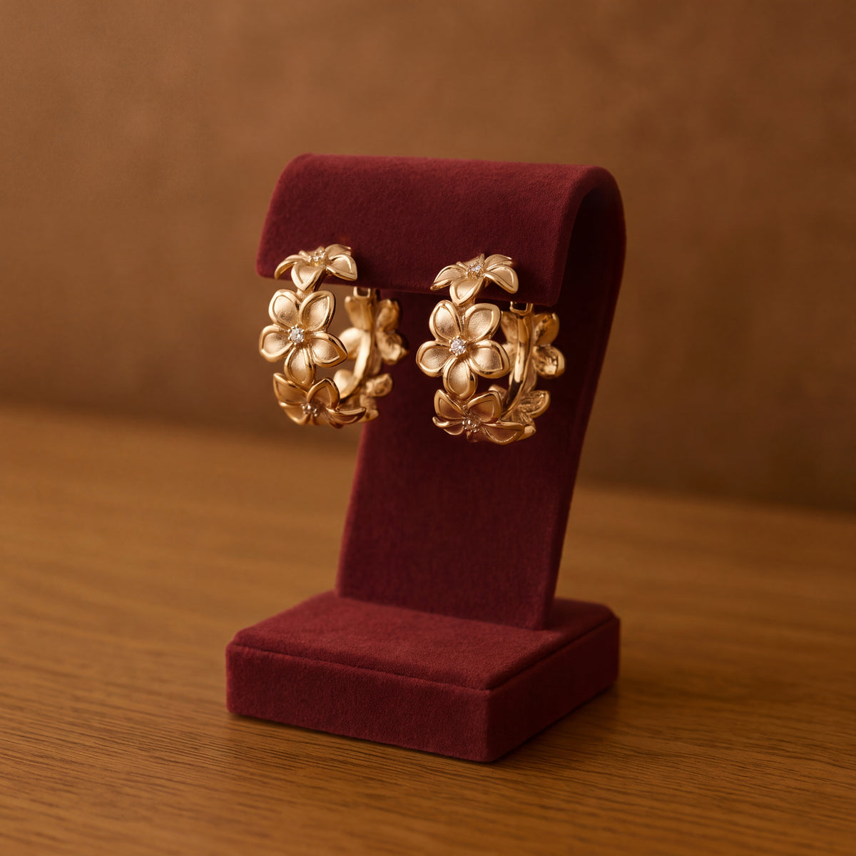 Yellow gold plumeria hoop earrings with diamond centers