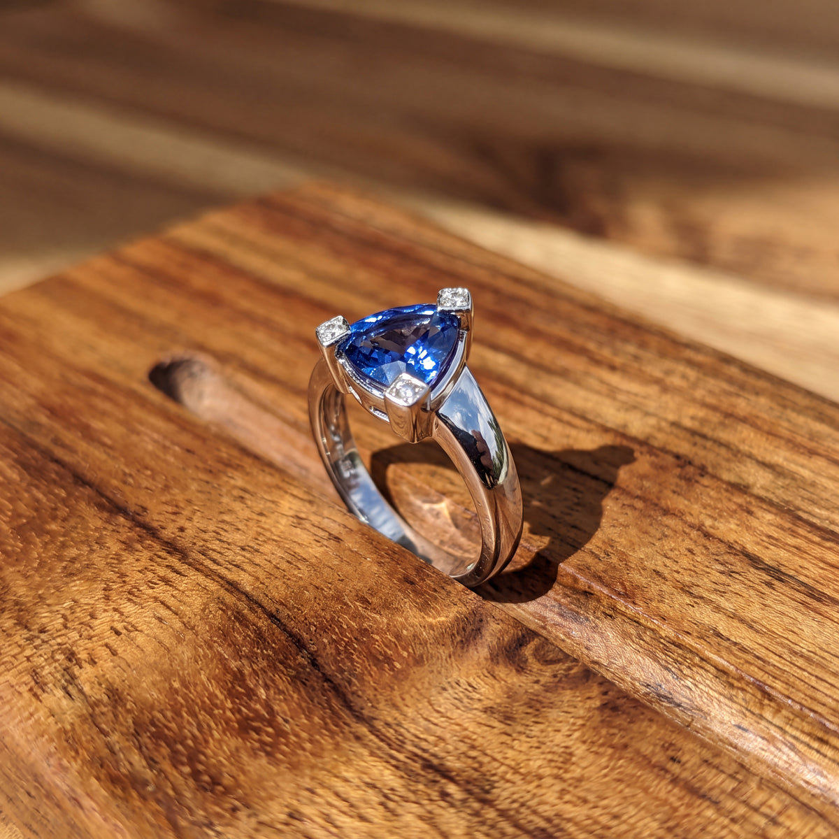 Trillion-cut tanzanite solitaire on a tapered white gold band