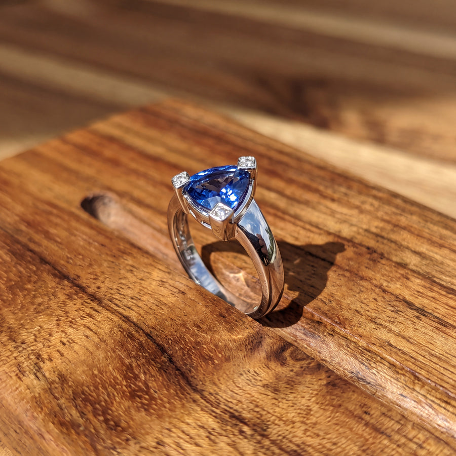 Trillion-cut tanzanite solitaire on a tapered white gold band