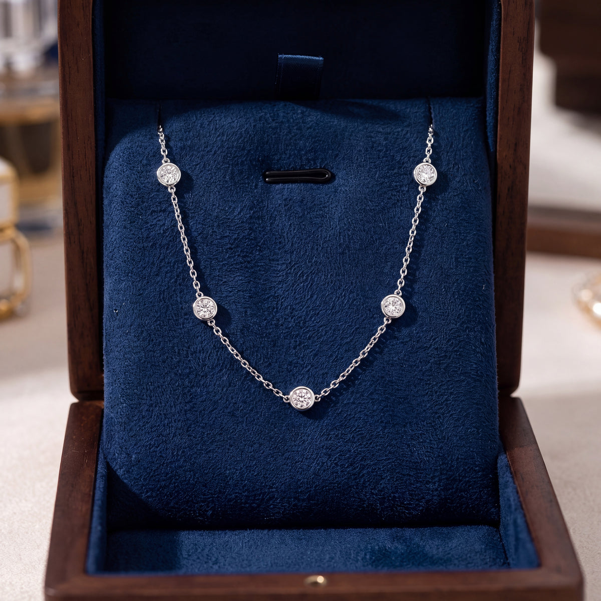 White gold station necklace with bezel-set diamonds