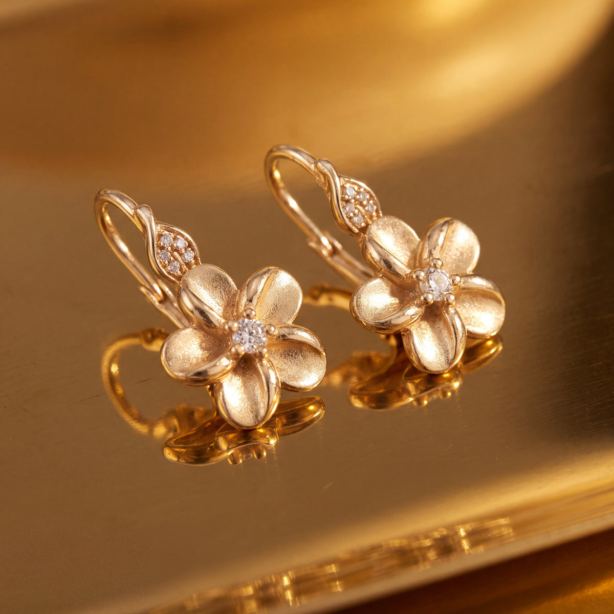 Yellow gold five-petal flower drop earrings with diamond centers