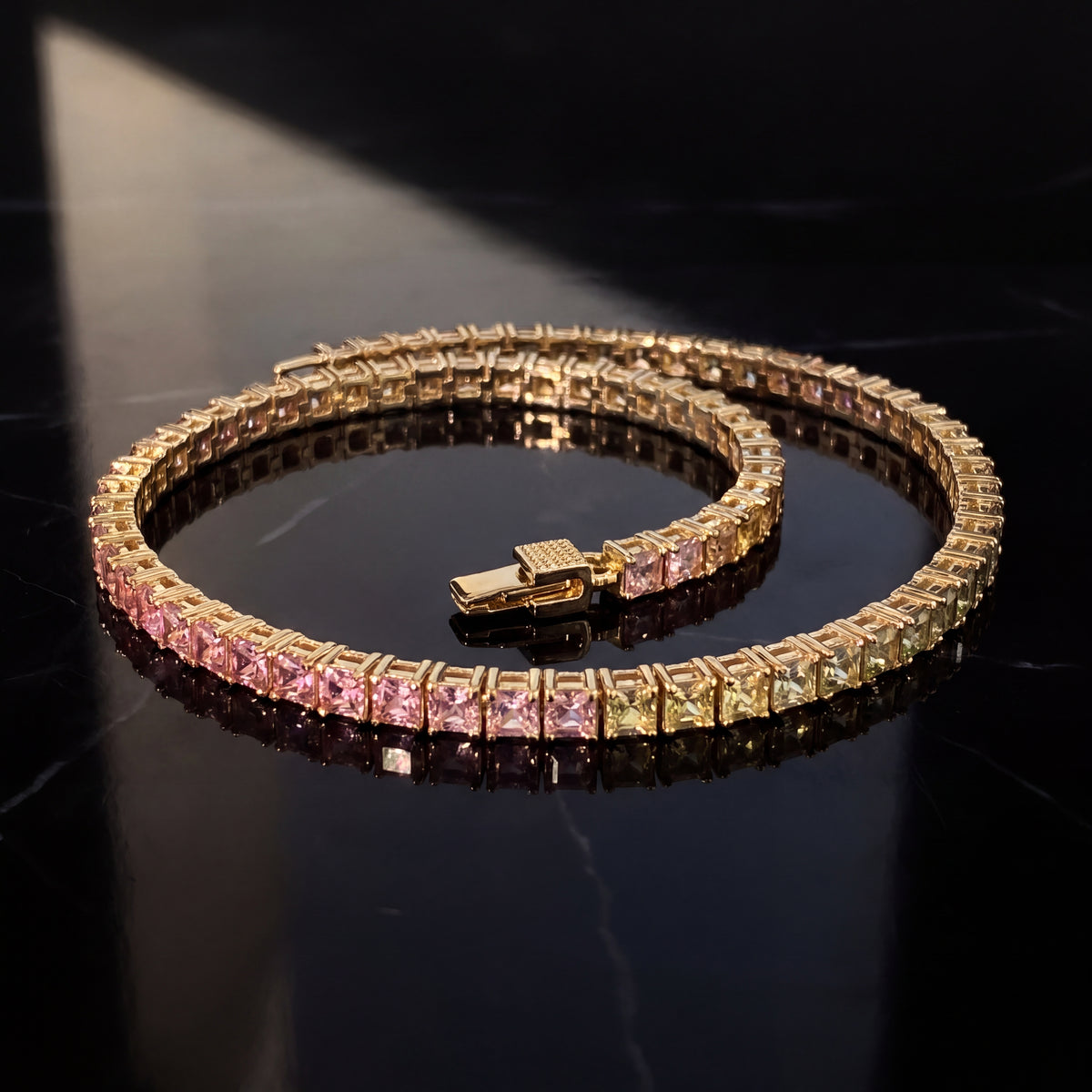 Yellow gold tennis bracelet of square sapphires in a color gradient