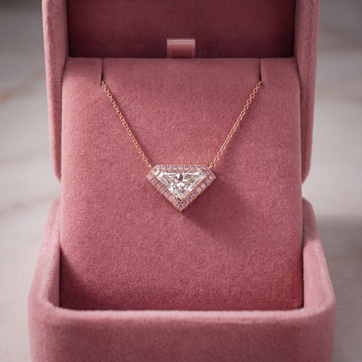 Inverted triangle diamond pendant in a halo, rose gold