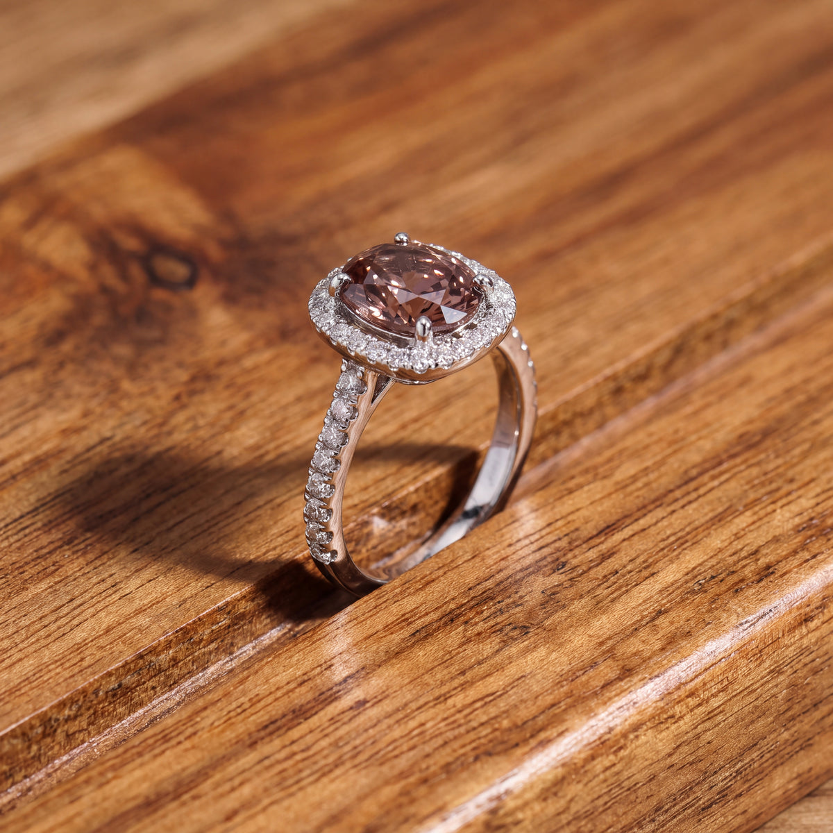 Chocolate zircon cocktail ring in a diamond halo on a white gold band set with diamonds