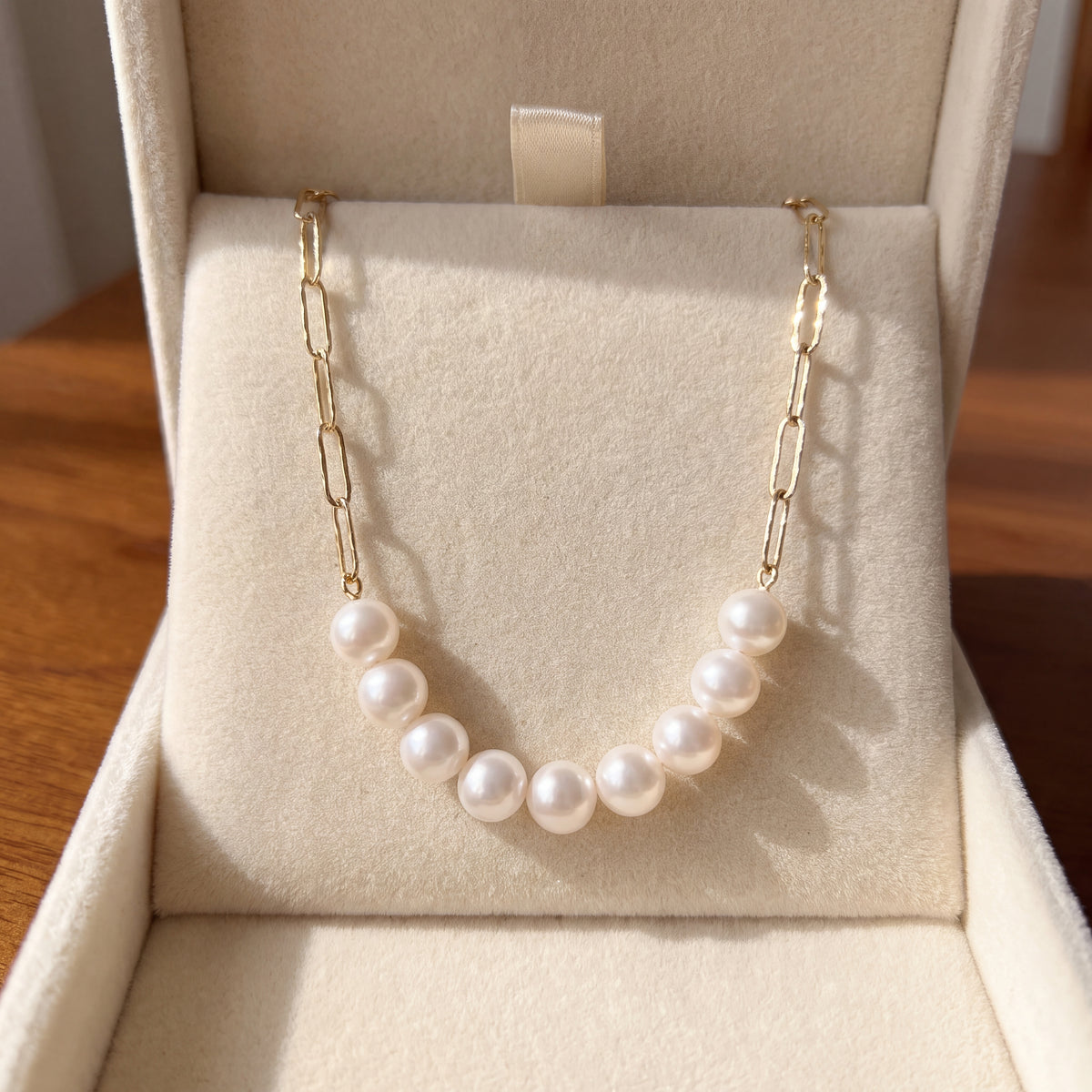 Paperclip link necklace with a row of white pearls